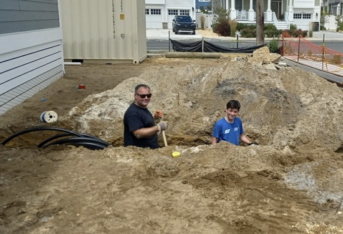 Ryan Fisher working in the trenches with his son